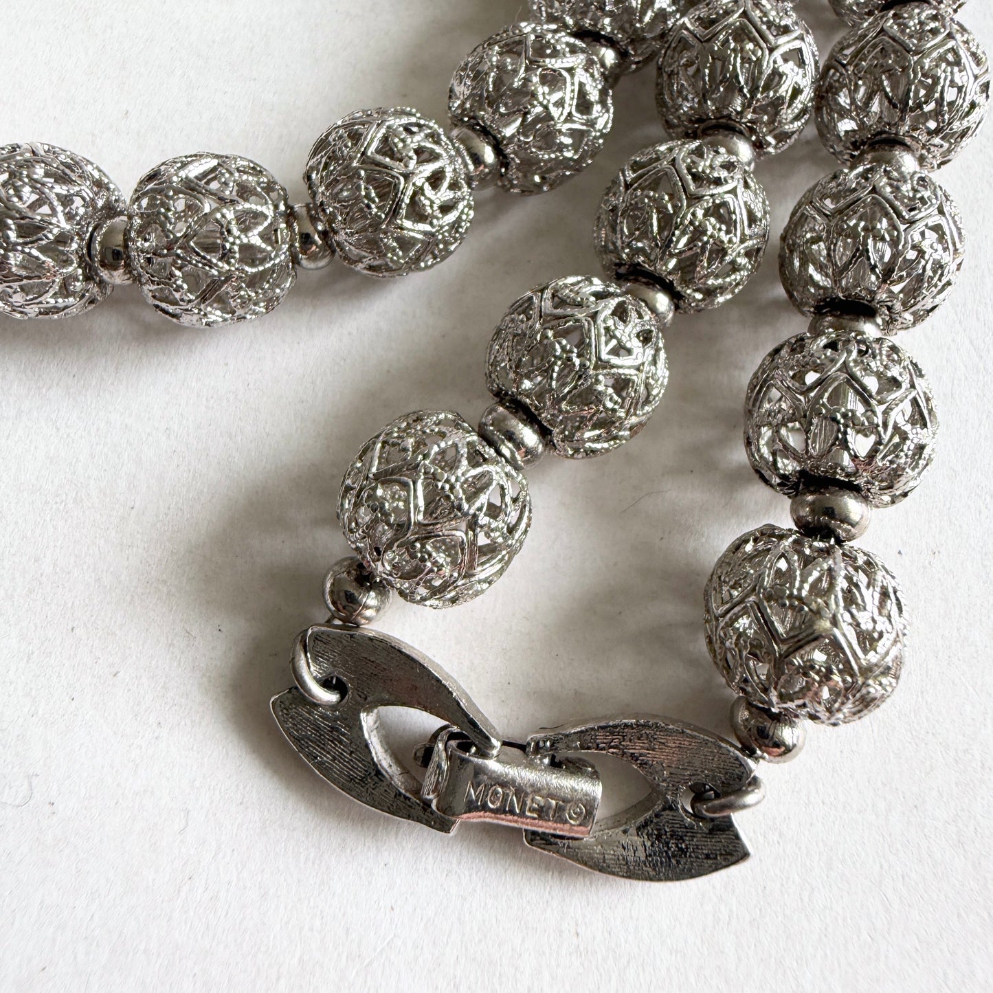 A detailed view of the MONET textured silver-tone fold-over clasp, highlighting the mechanical quality and craftsmanship.
