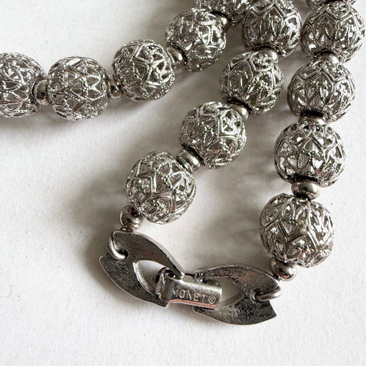 A detailed view of the MONET textured silver-tone fold-over clasp, highlighting the mechanical quality and craftsmanship.
