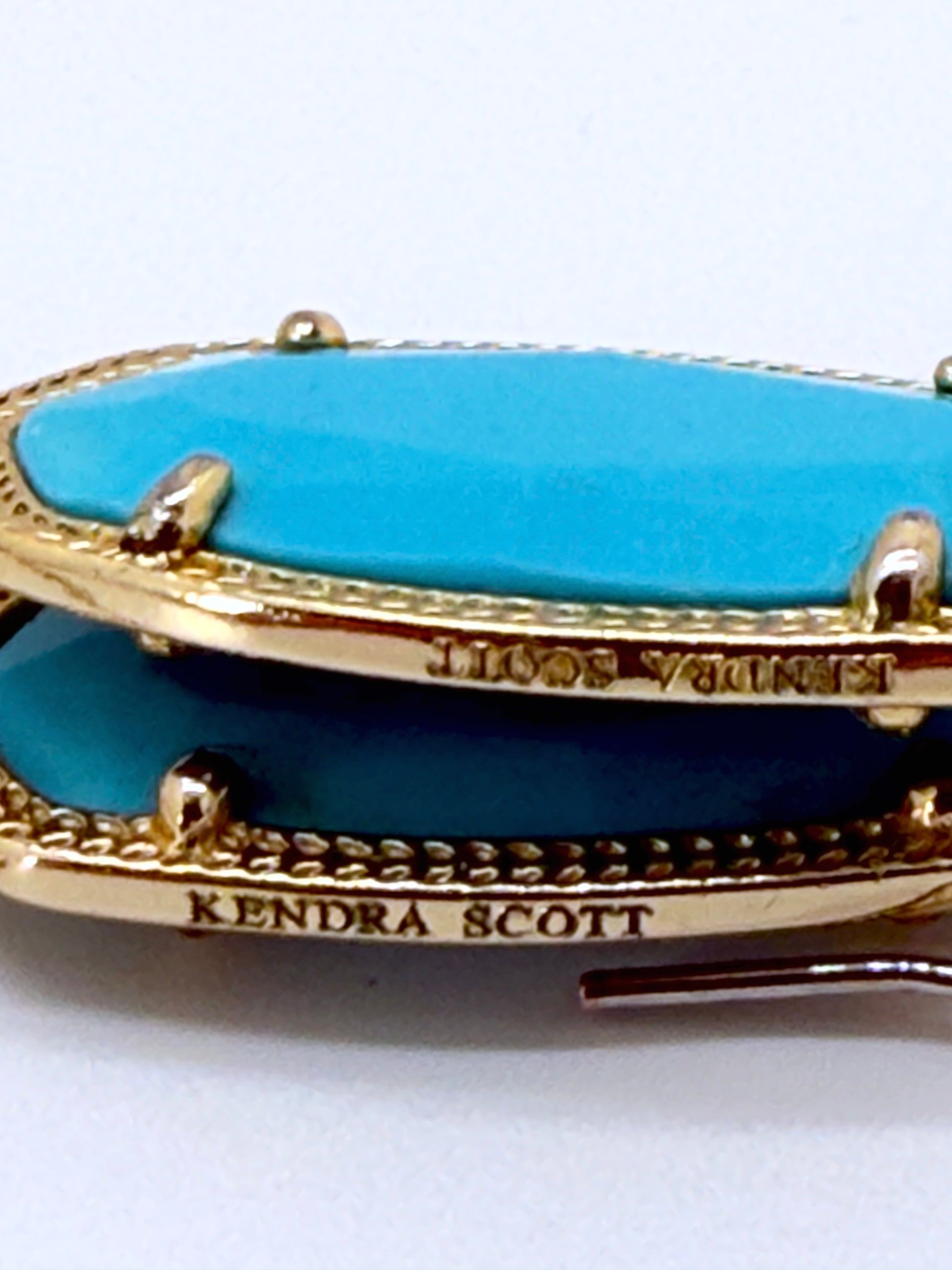 earring gold border and turquoise center, branded 'Kendra Scott'.