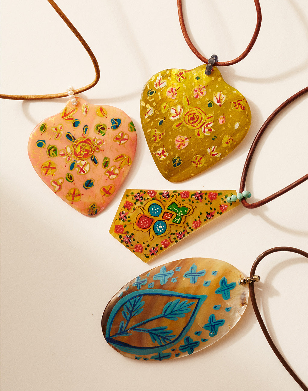 Set of colorful chan-luu heart-shaped pendants on a white background