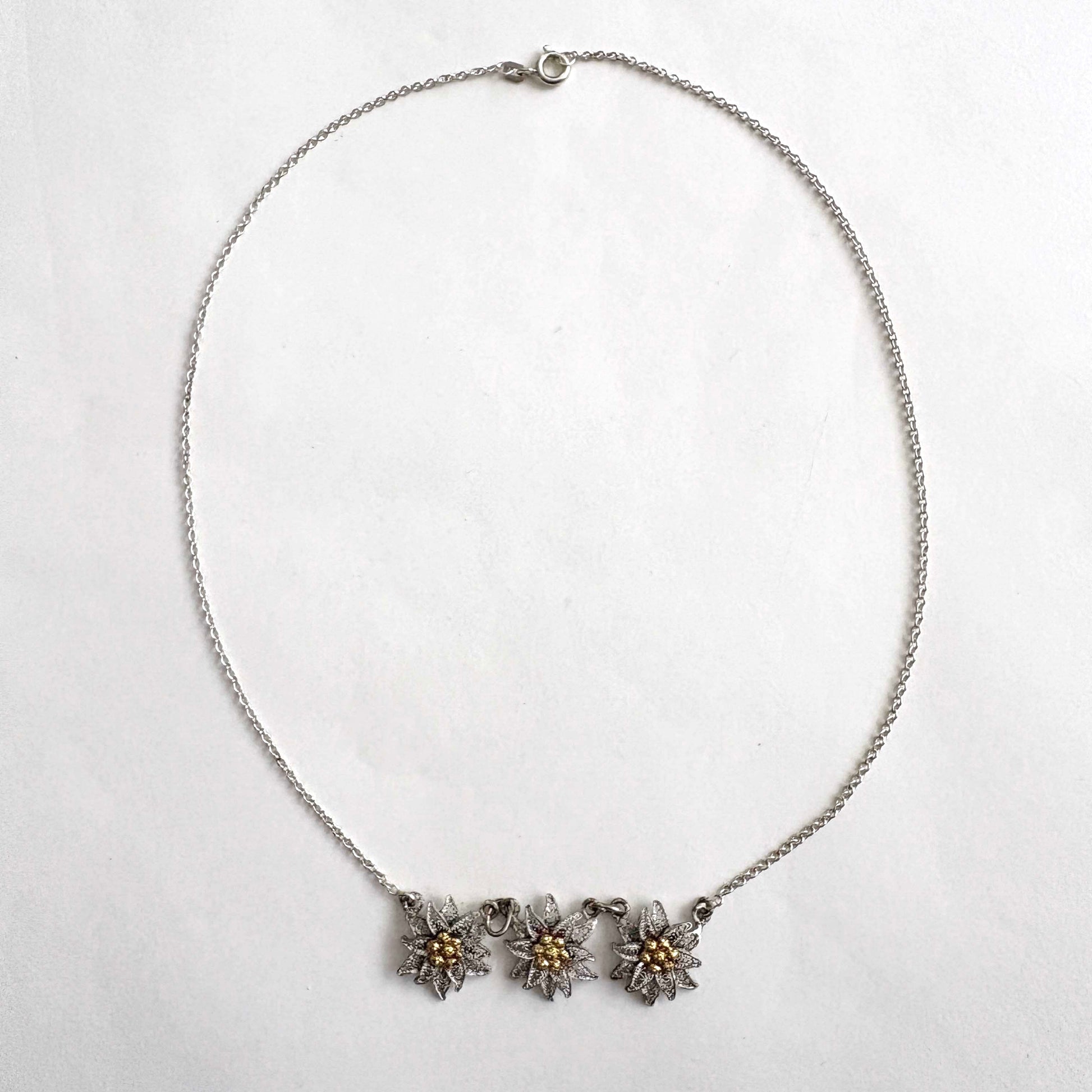 Necklace with three floral edelweiss pendants on a white background