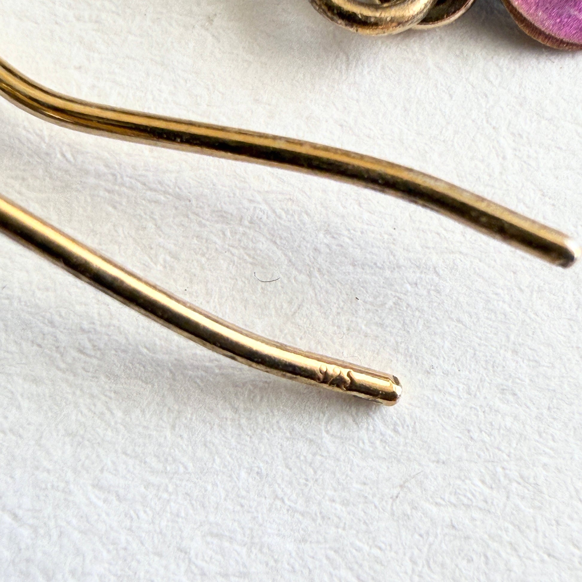 Gold earring wire on a white background