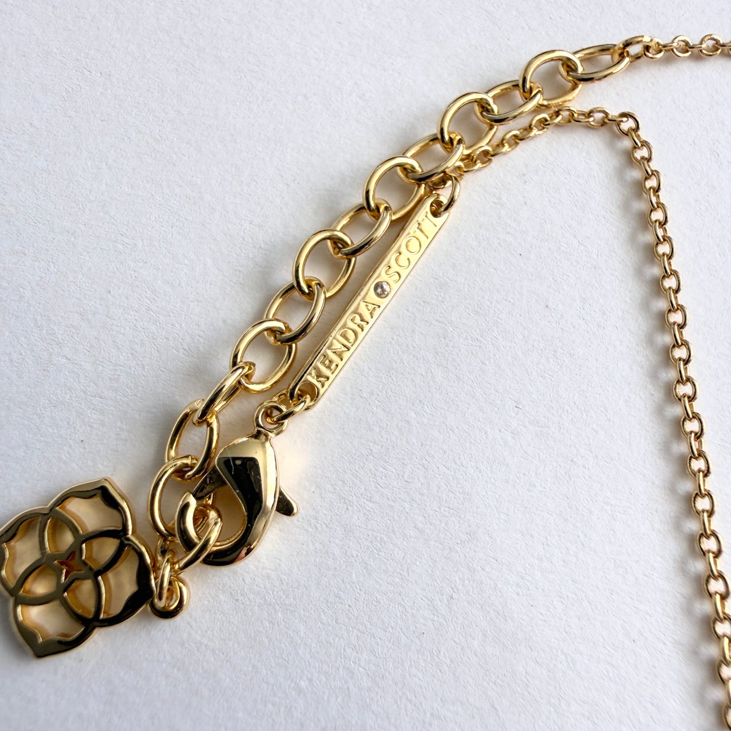 Gold chain necklace clasp on a white background