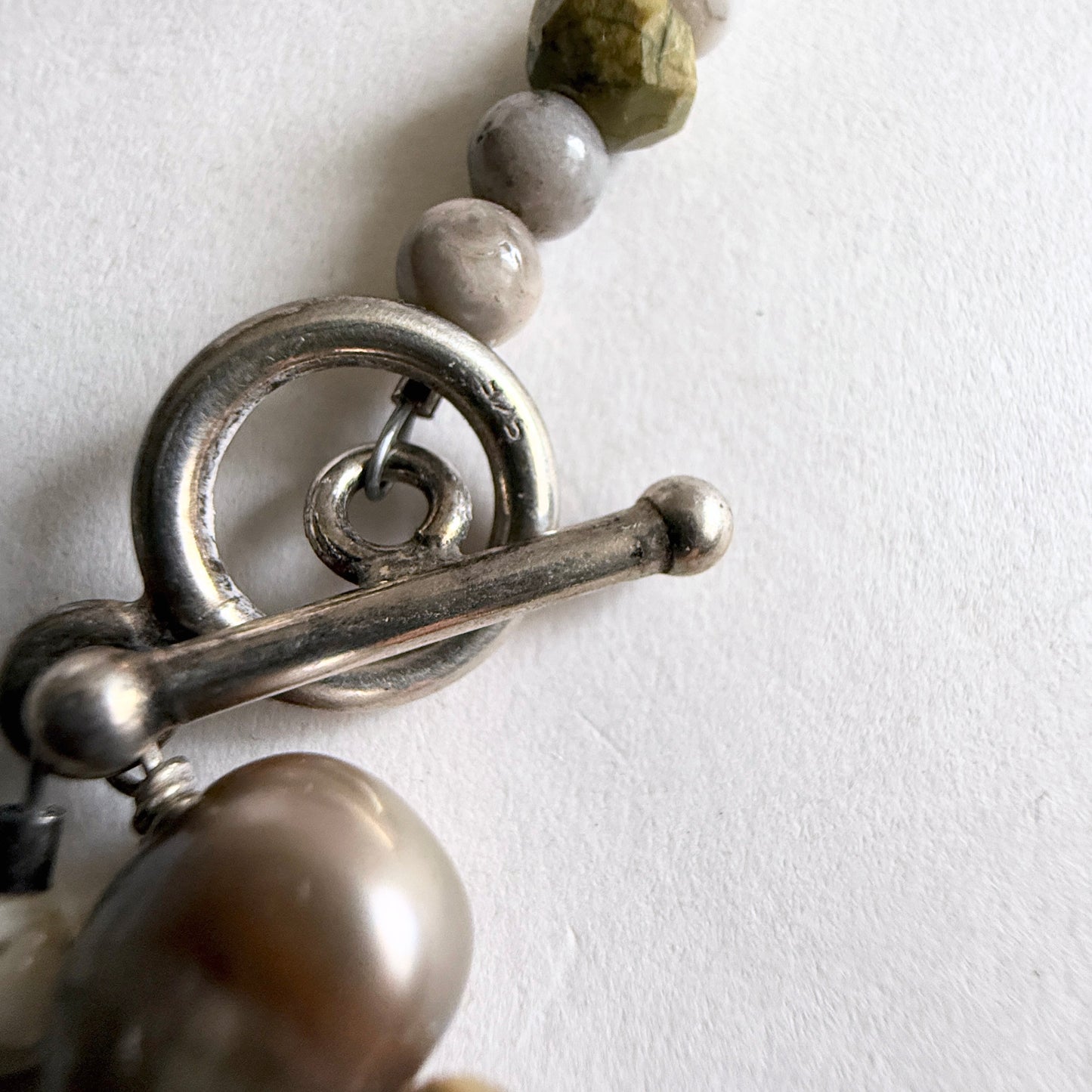The secure sterling silver toggle clasp and hand-strung bead construction of the Littoral Artisan Moonstone Strand.