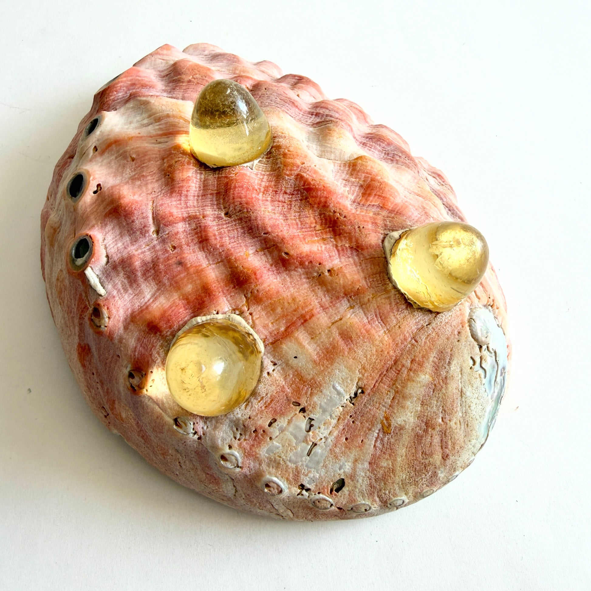 The base of the bowl showing the secure attachment of the hand-cast Lucite tripod legs and the natural exterior texture.