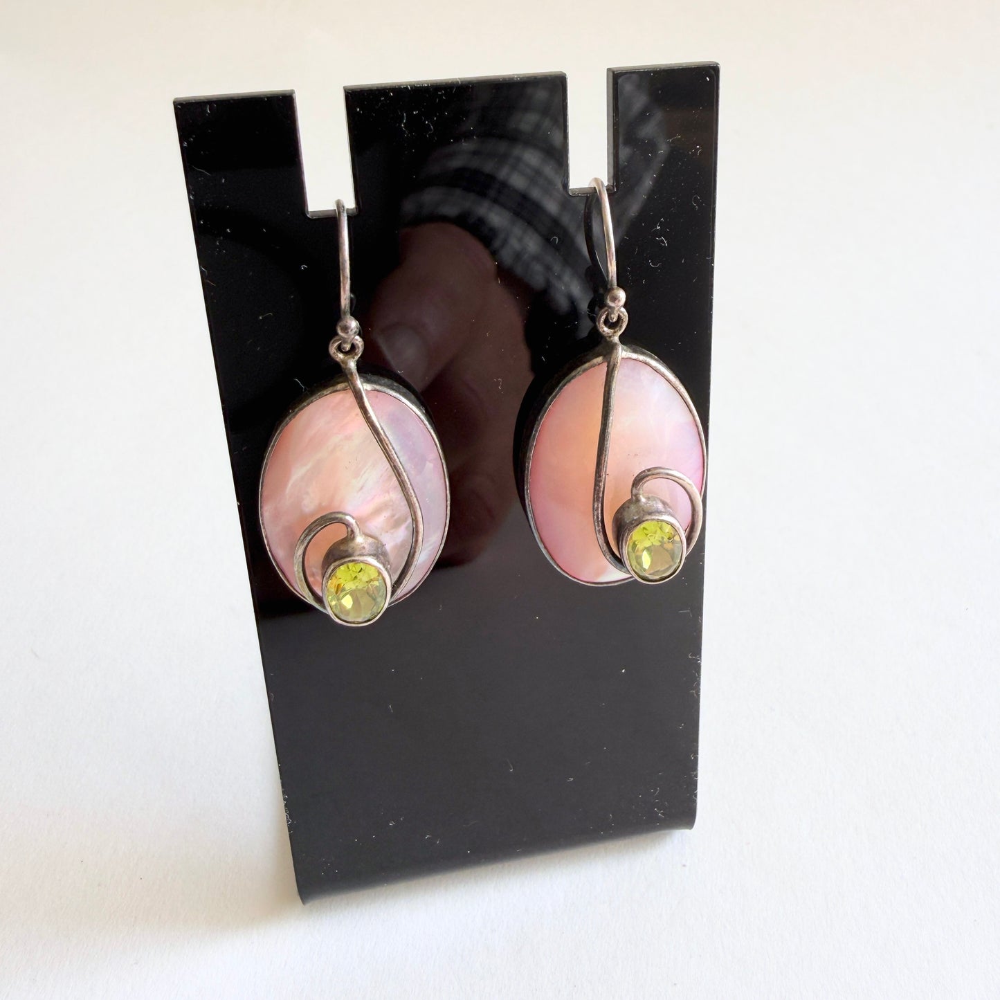 Side profile showing the hand-fabricated bezel construction and the sculptural 'floating' silver detail.