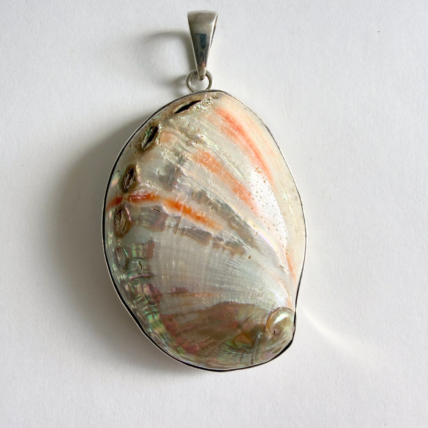 Full view of the 'Coastal Fragment' Charles Albert pendant, featuring a large, natural abalone shell in a .950 fine sterling silver bezel.