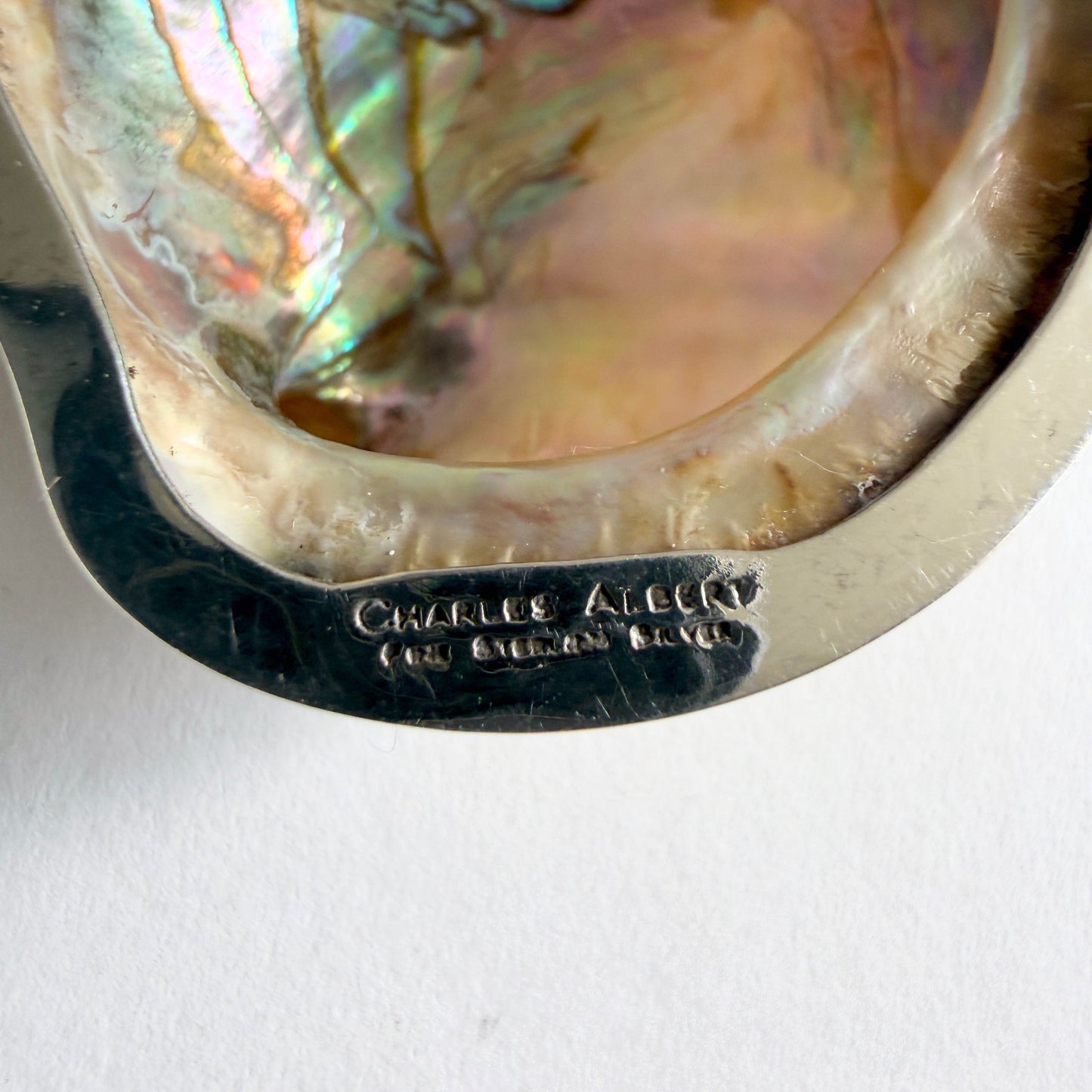 Back of the pendant showing the signature 'Charles Albert / Fine Sterling Silver' hallmark and the substantial scale of the piece.