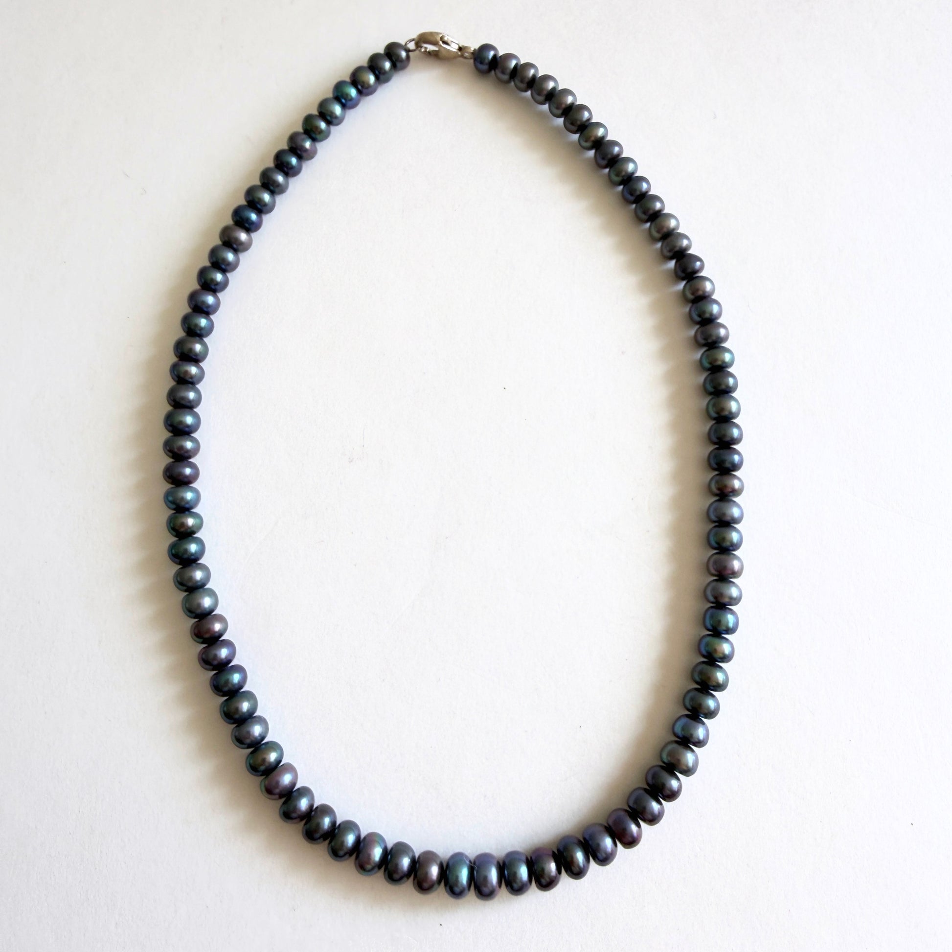 A 14-inch peacock pearl choker necklace featuring dark iridescent freshwater pearls on a white gallery background.