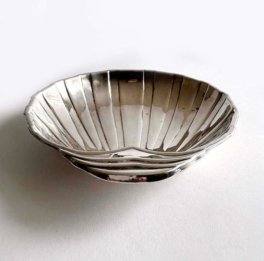 Close-up of the scalloped hinge detail and the luminous silver-plate finish with authentic vintage patina.