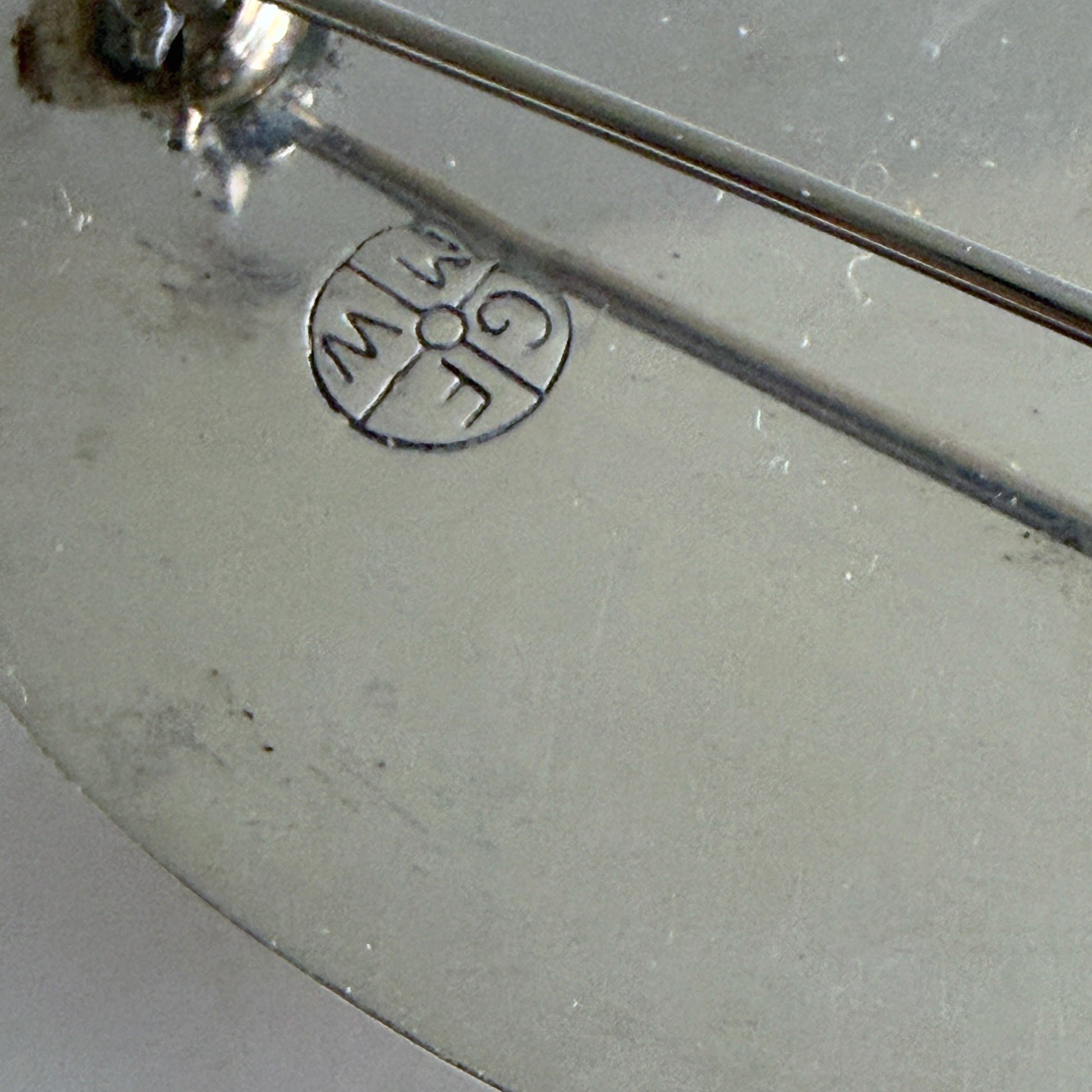 The reverse of the brooch showing the authentic 'GFMW' hallmark.