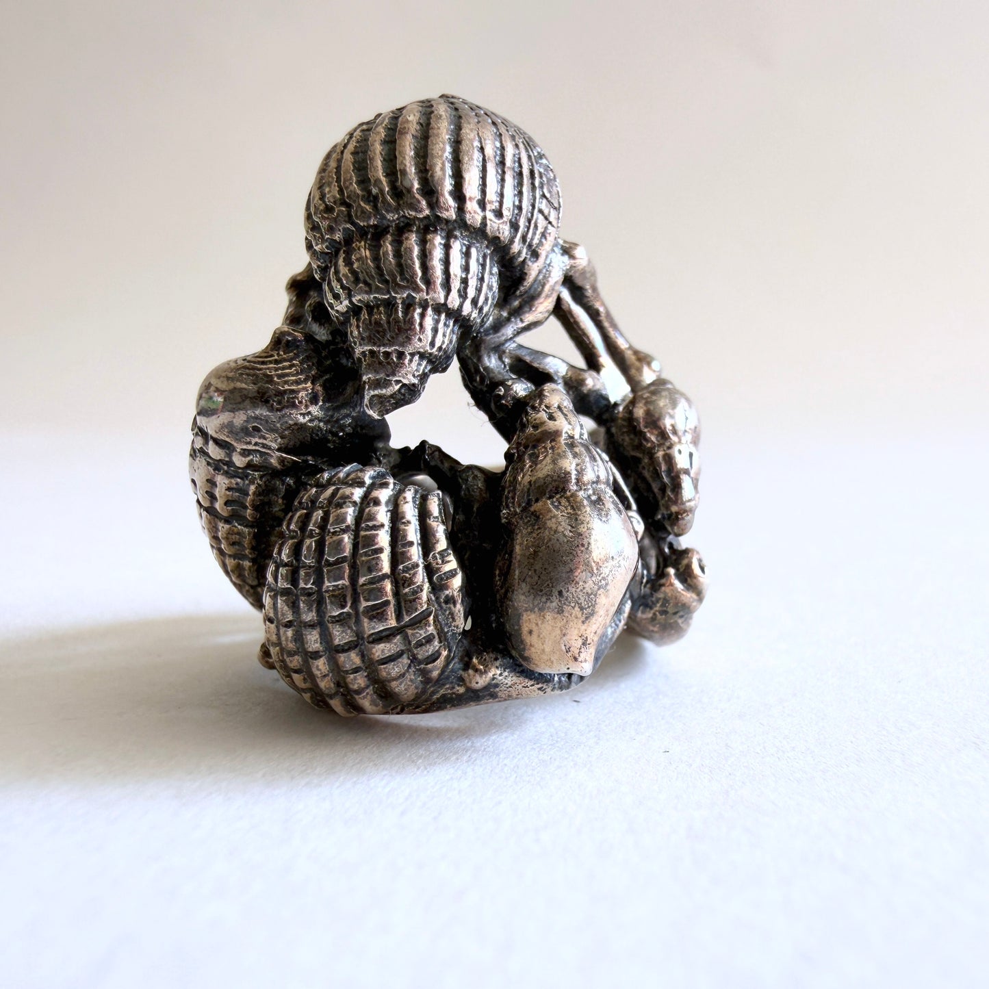 View of the ring displayed on a white background, showcasing its substantial scale and organic coastal aesthetic.