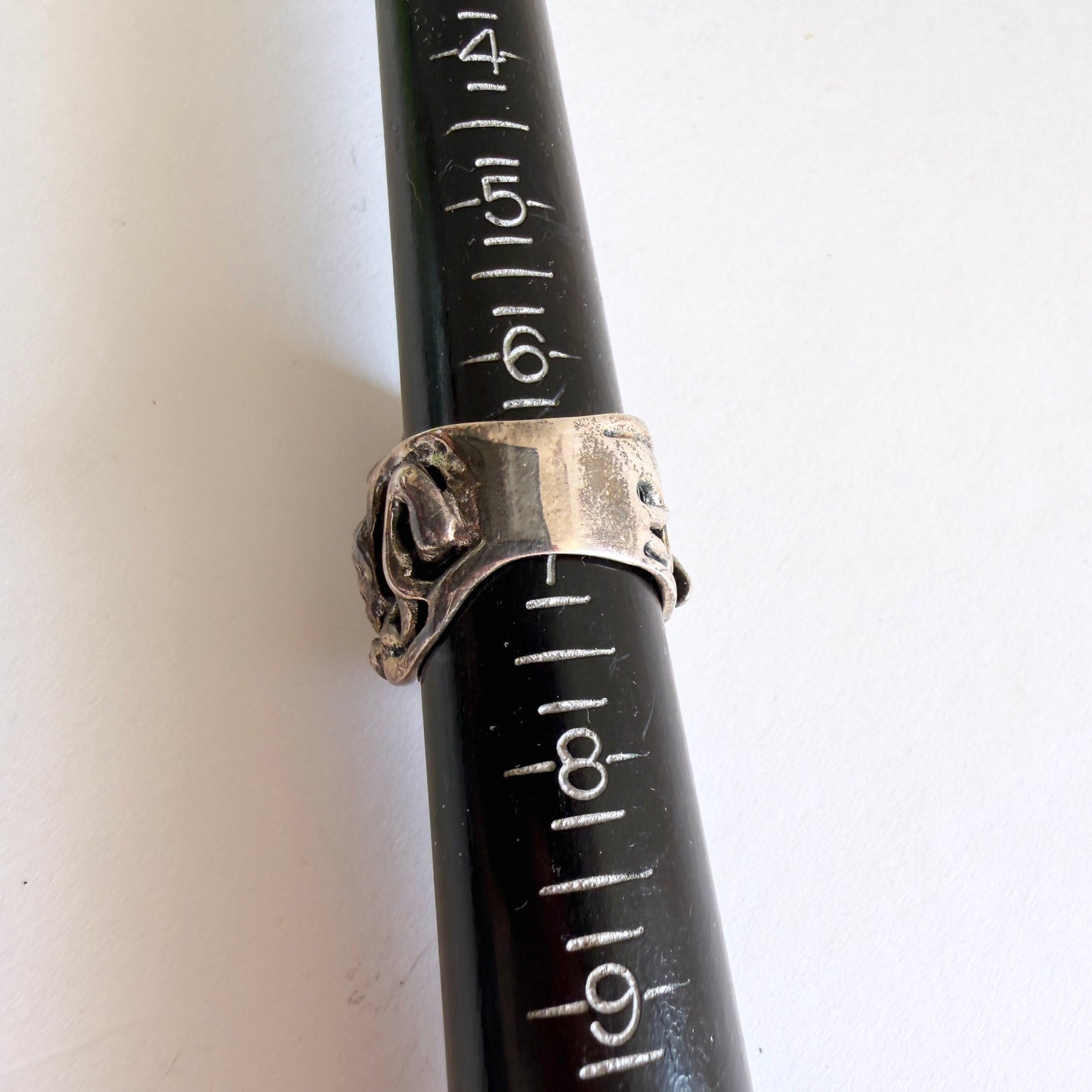 The Grotto statement ring shown on a professional metal ring mandrel, indicating a size of approximately 6.75.