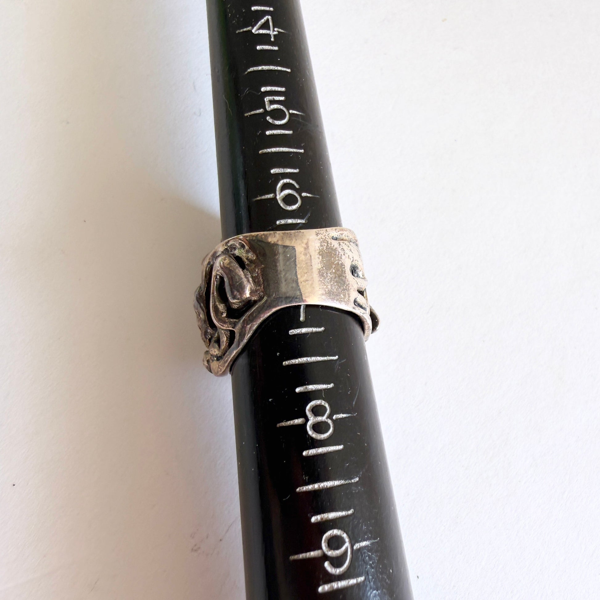 The Grotto statement ring shown on a professional metal ring mandrel, indicating a size of approximately 6.75.