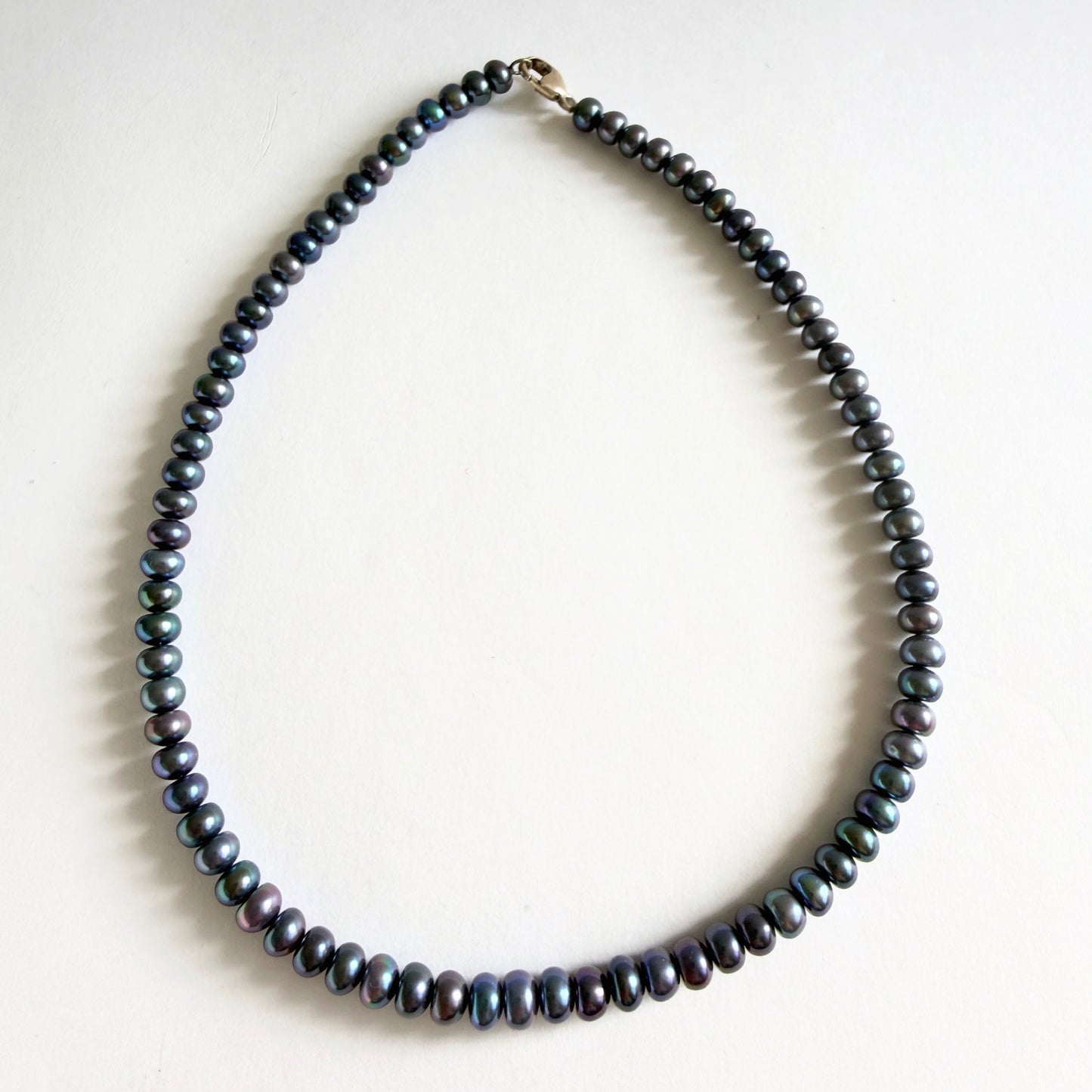 A 14-inch peacock pearl choker necklace featuring dark iridescent freshwater pearls on a white background.