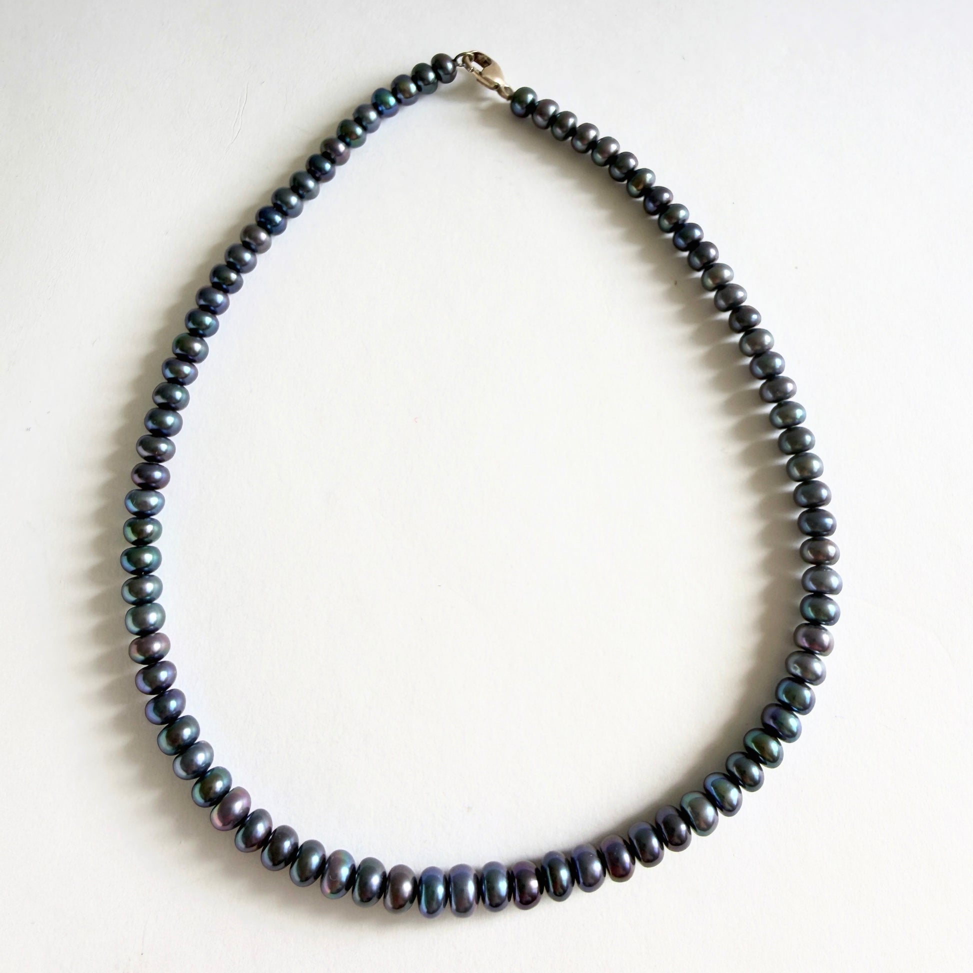 A 14-inch peacock pearl choker necklace featuring dark iridescent freshwater pearls on a white background.