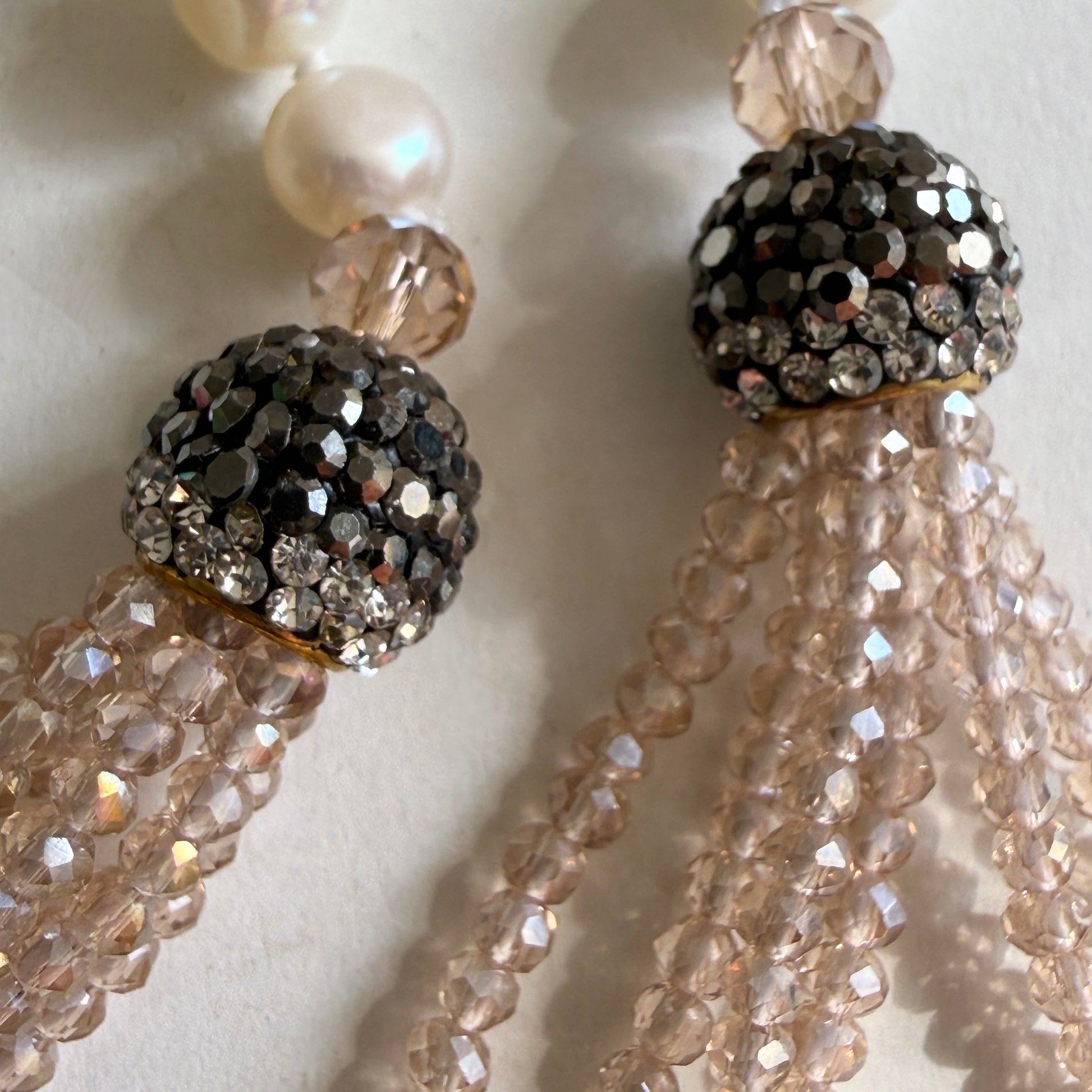 Detailed view of the pavé crystal spheres and faceted beads, highlighting the 'coastal glamour' light-catching effect.