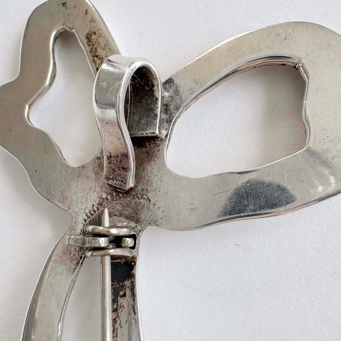 Close-up of a silver bow on a white background