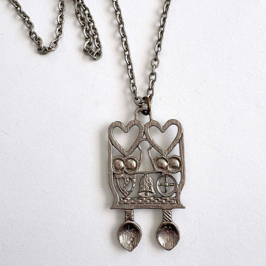 Silver pendant necklace with Welsh Spoon heart design on a white background