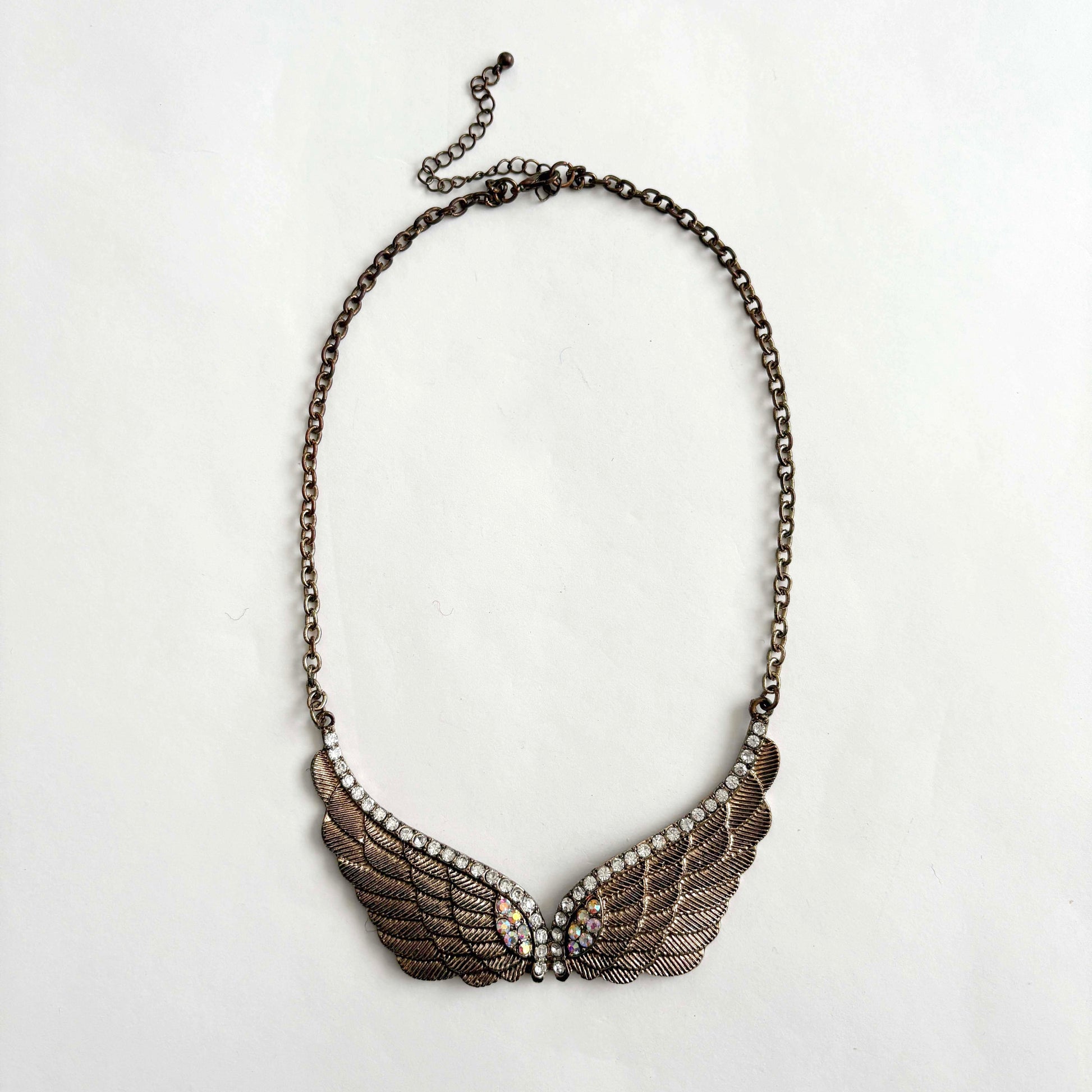 Necklace with wing-shaped pendant on a white background